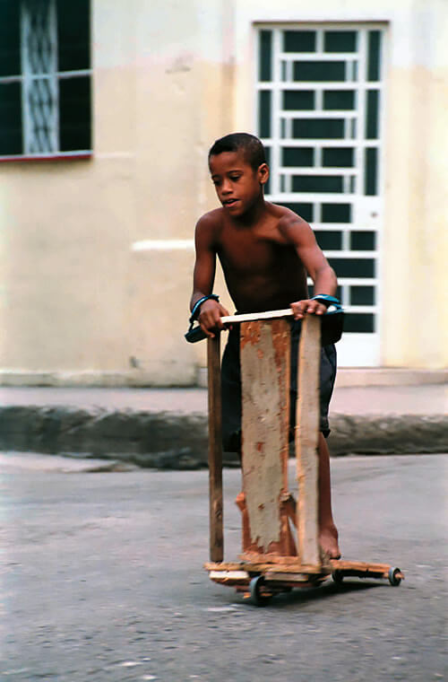 Photo of child riding home-made scooter in Cuba.