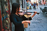 Woman playing violin on a Polish street.