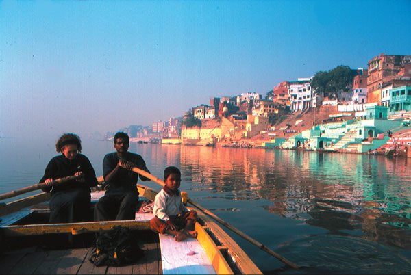 Teen rowing on the river Ganges in India