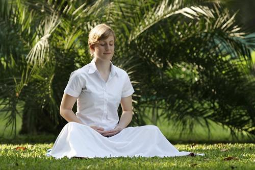 Woman meditating at a Buddhist retreat.