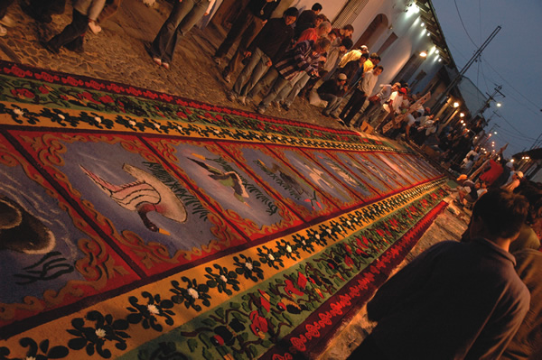 Guatemala sacred carpets on street at dawn.
