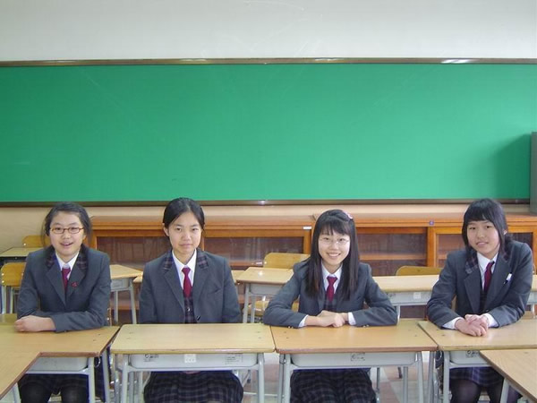 Uniformed public school students in class.