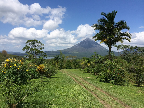 Costa Rica landscape with lake and volcano in background.