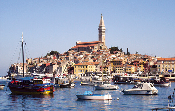 The old fishing village of Rovinj, Croatia on the Adriatic is surrounded by boats.