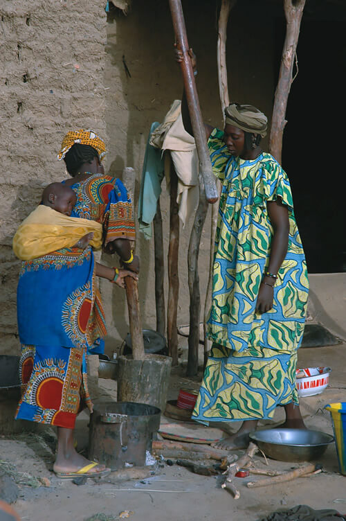 Fulani women pound millet.