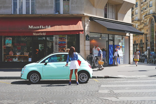 Women getting into her car on a Paris street.