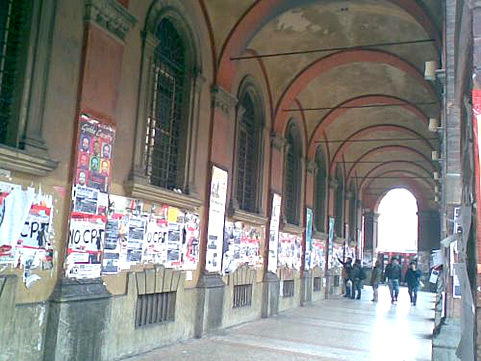 Bologna portico with students and announcements