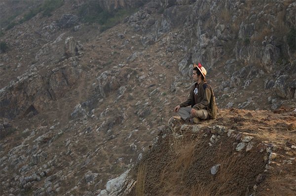 Buddhist Studies in India sitting a mountain ledge.