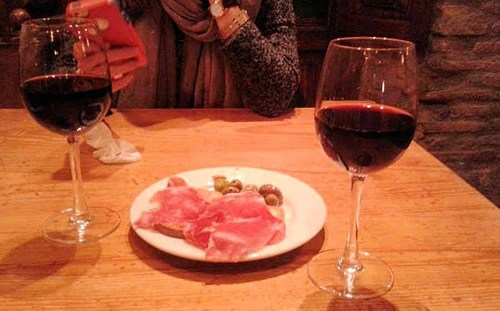 Tapas of jamon, olives, and red wine