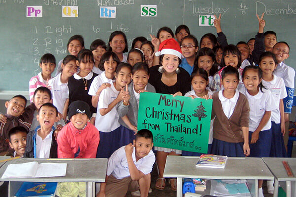 The author as as volunteer in a classroom with her students who she taught English in Thailand.